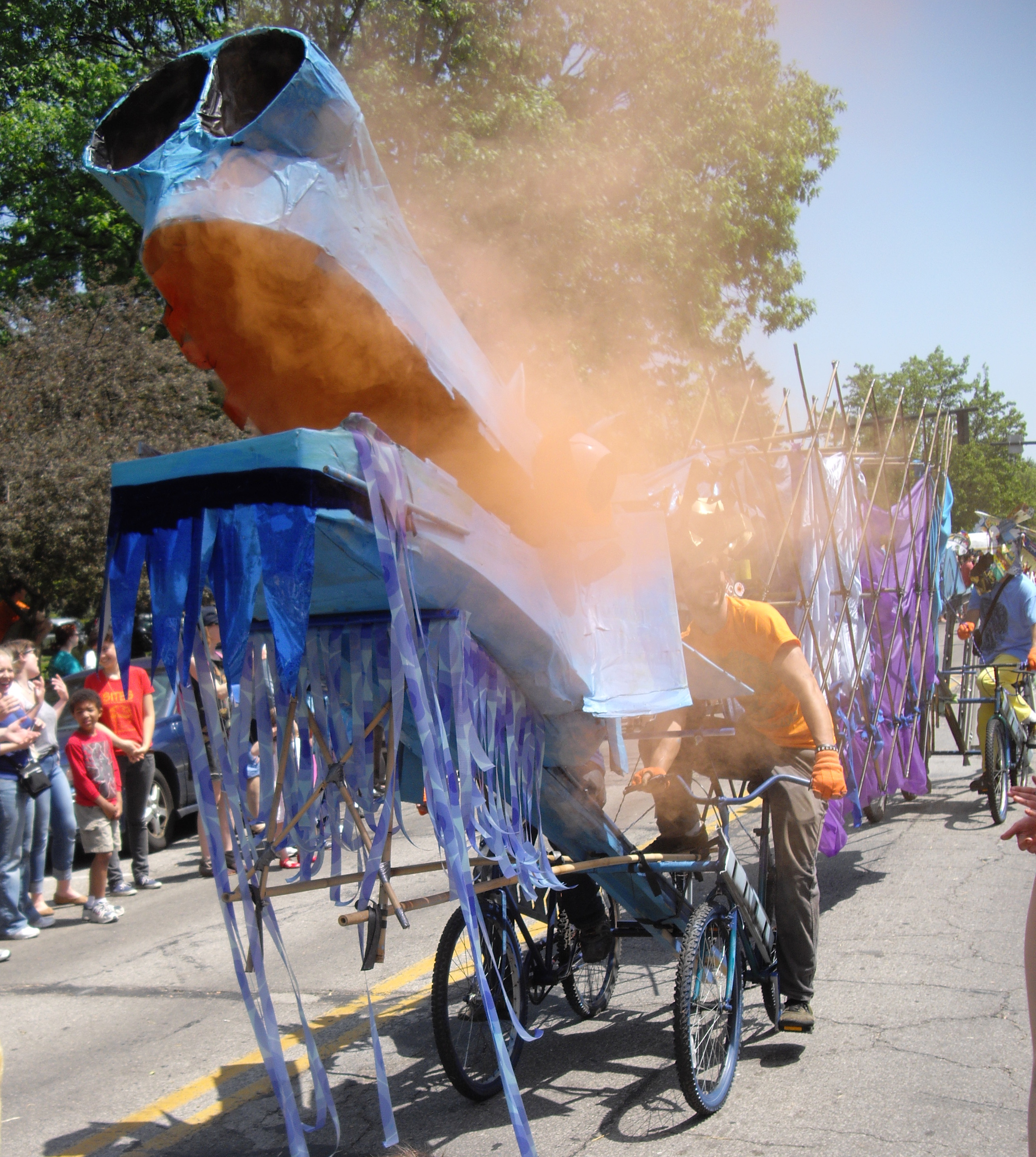 A bicycle-powered dragon makes its way down College Street during the Big Parade