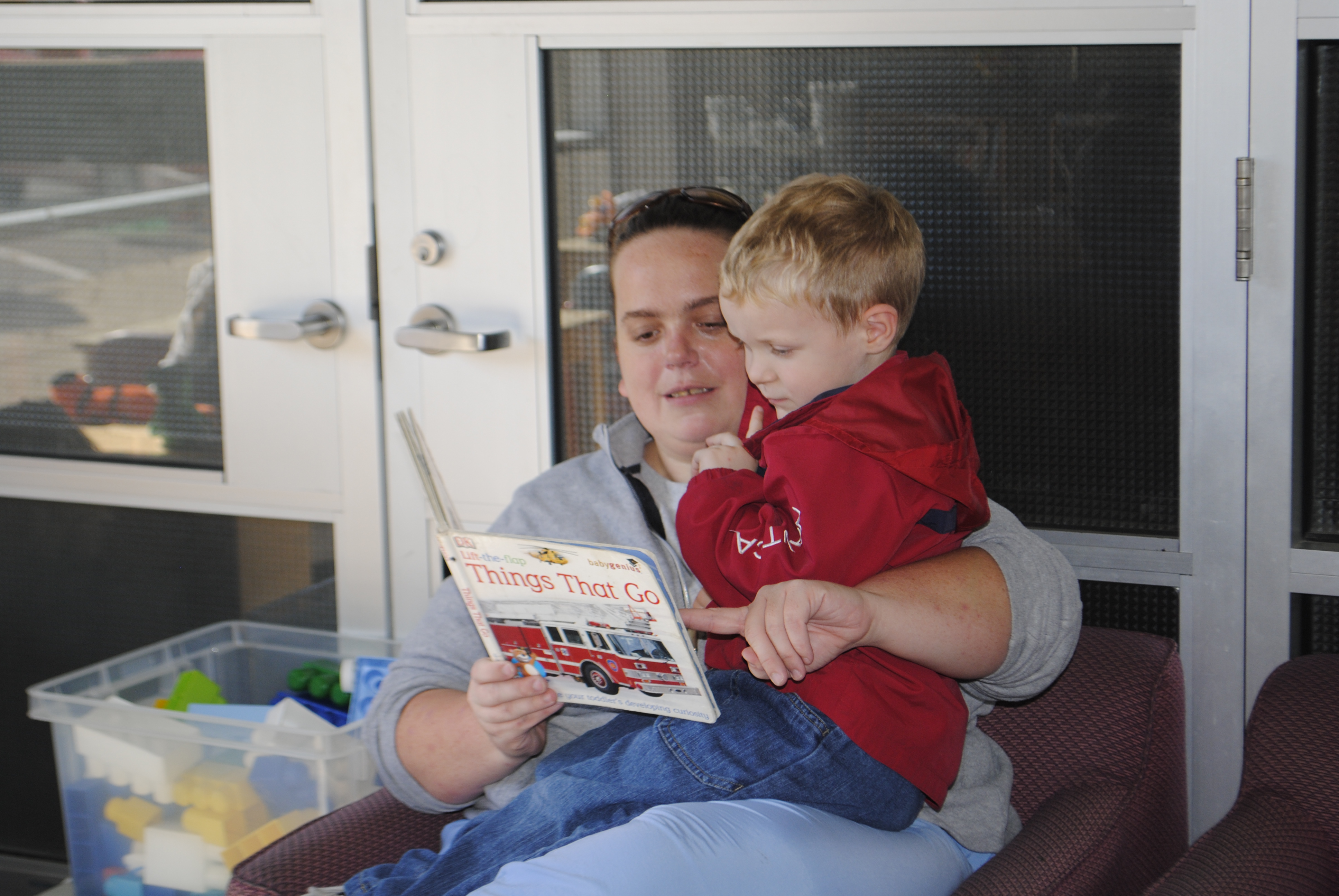 Mother and Son read a book together at the Library