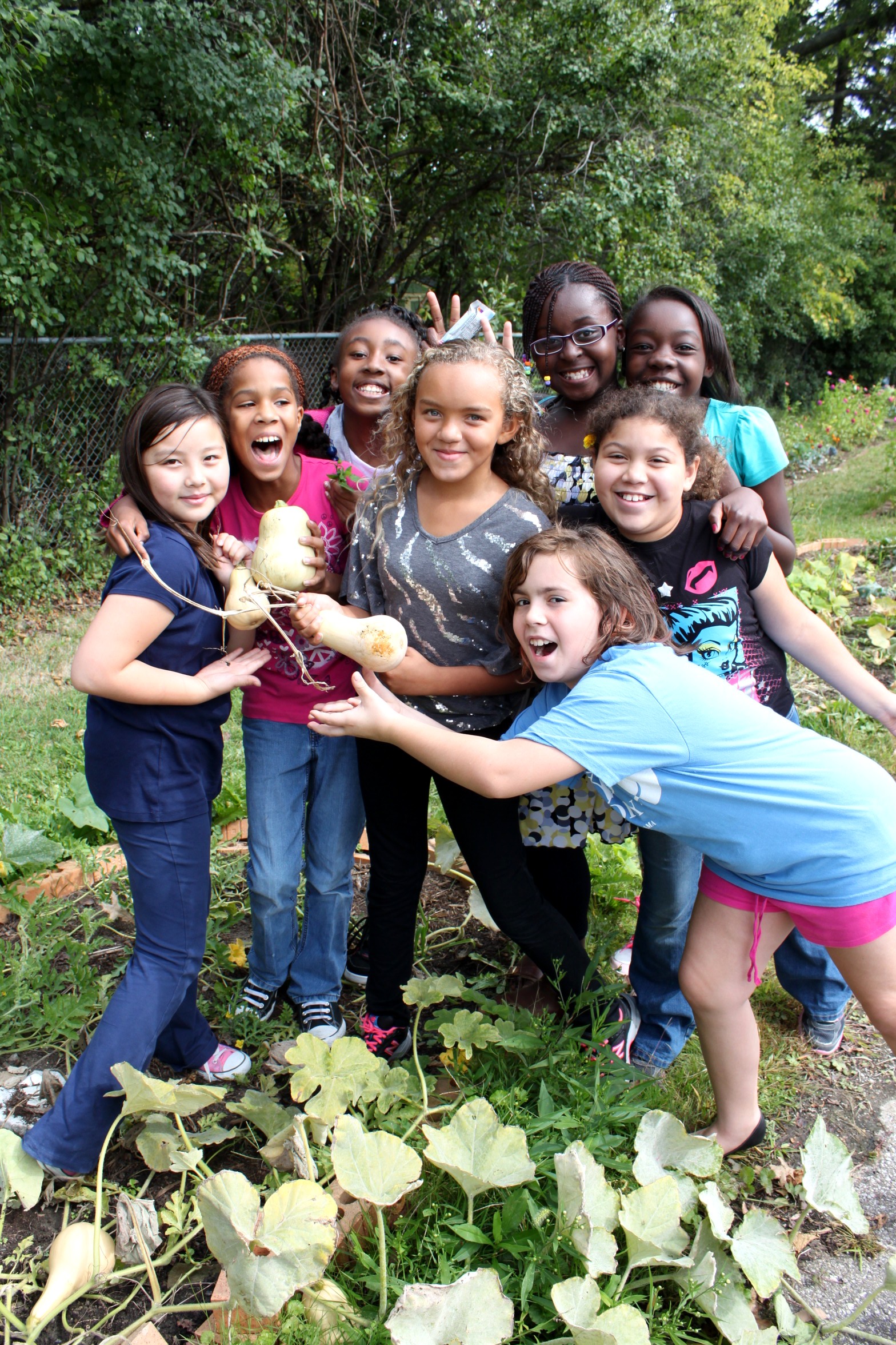 Prospect Elementary students pose in the Learning Garden with squash they just picked off the vine.
