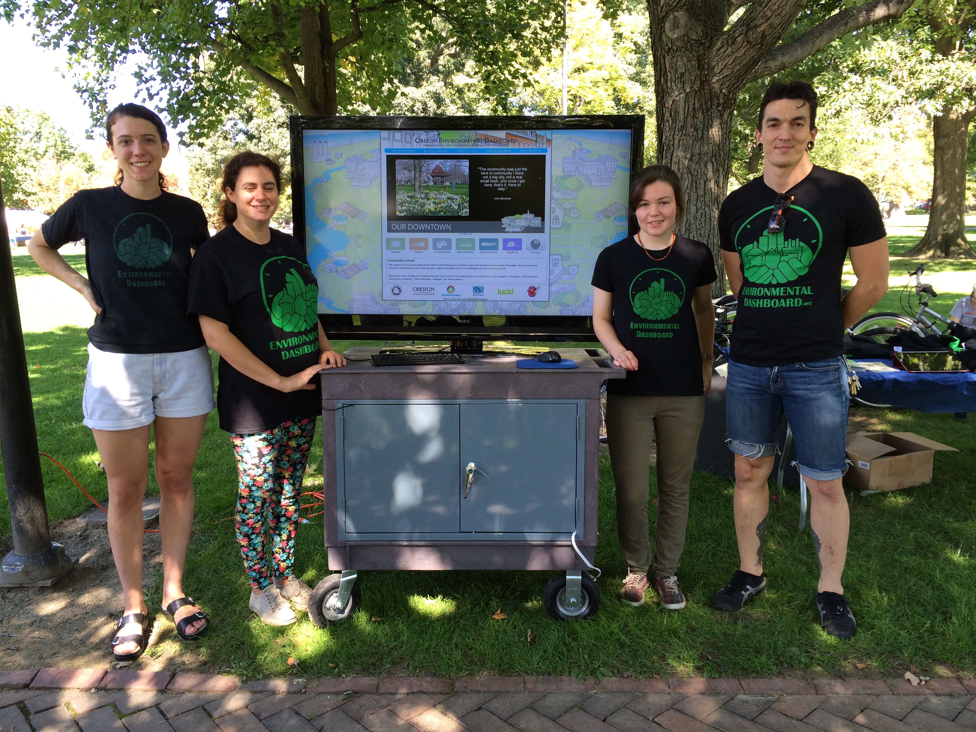 Sam with students and Digital Signage